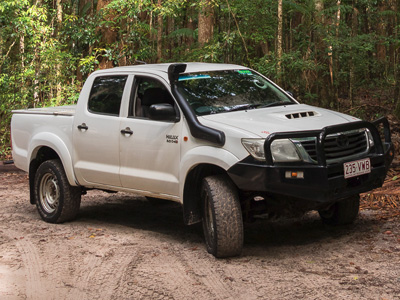 White Toyota Hilux dual-cab ute with snorkel, prepared for K'gari